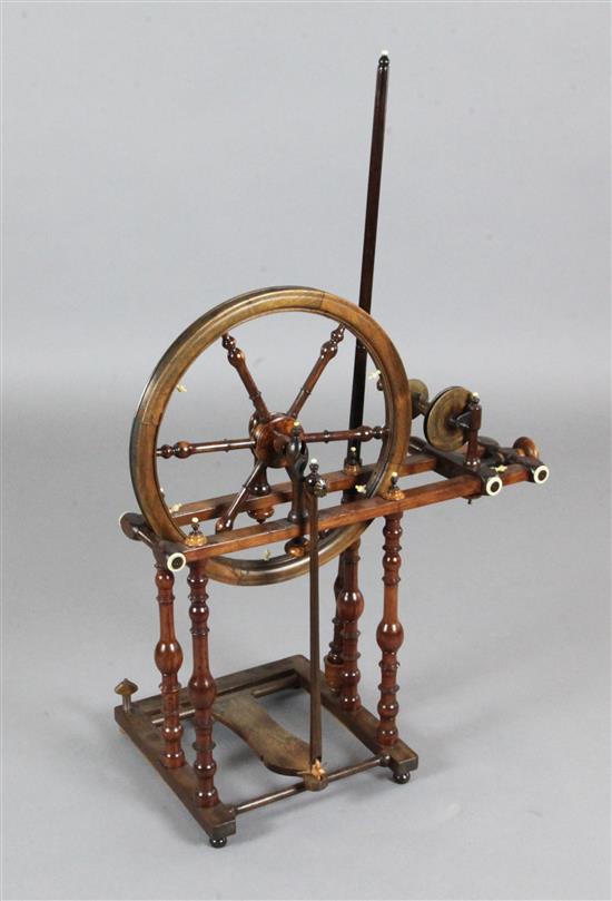 An early 19th century mahogany, oak and fruitwood spinning wheel, W.2ft H.3ft 3in.